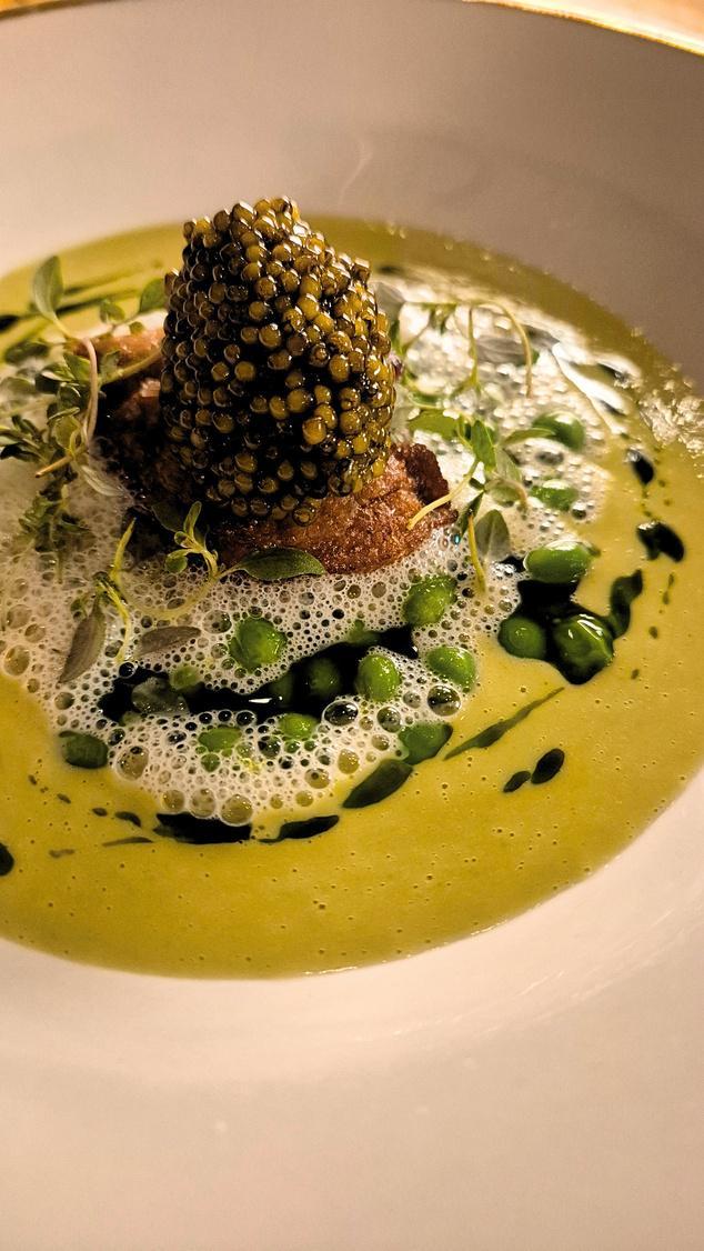 Refined caviar dish on green sauce