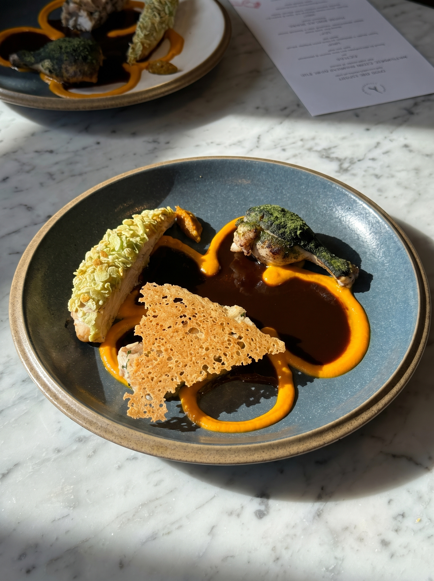 Plated chicken with jus, herb crust and tuile